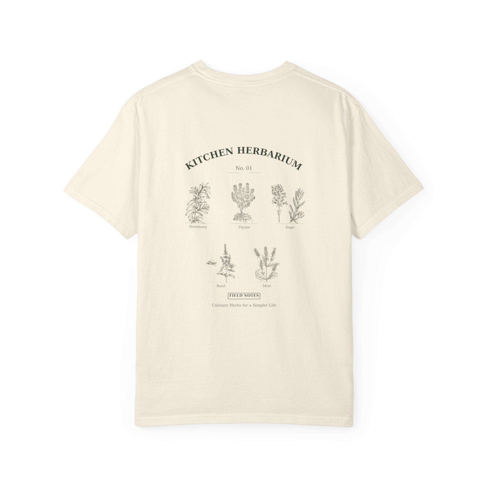 Actual Etsy manufacturer mockup of the Kitchen Herbarium Ivory T-shirt, showing the complete botanical back print